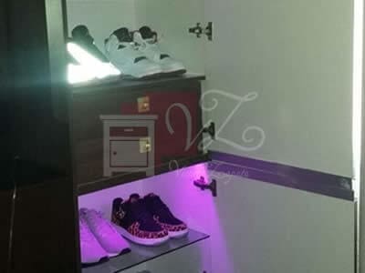 Zapatera de melamina color caoba con iluminación.